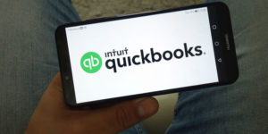 Man accesses Intuit QuickBooks Online Mobile App