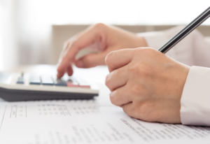 A financial expert using a calculator to track business finances.