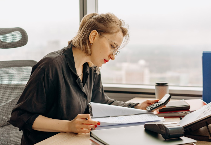 An accountant balancing the books at her desk